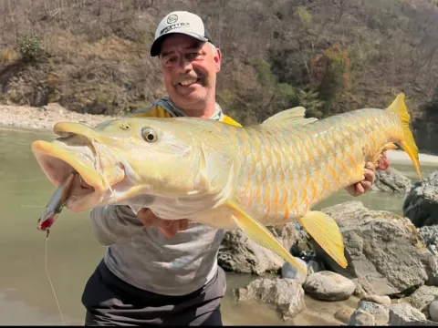 Angler casting a lure during a Seti Karnali fishing expedition