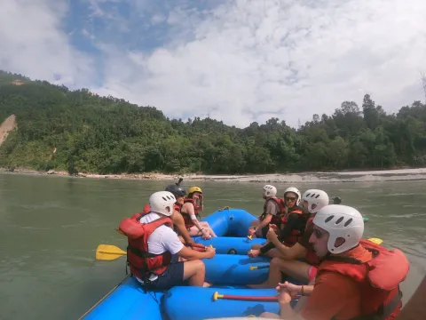 Rafting group paddling through whitewater rapids on the Bhotekoshi River