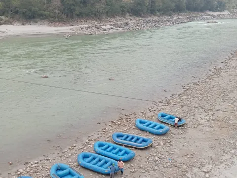 Rafting boat floating through a peaceful scenic section of the Lower Seti River