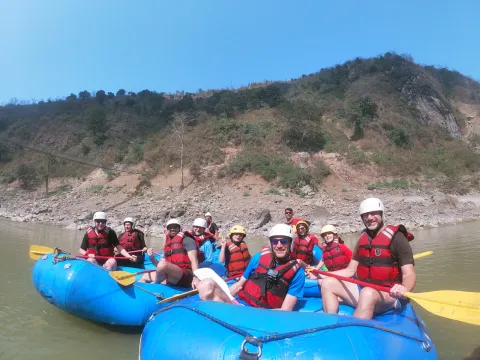 Happy family celebrating an unforgettable whitewater adventure in Nepal
