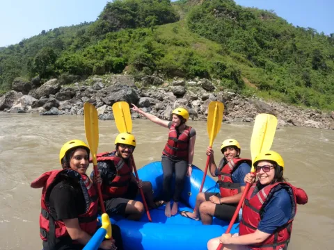 Rafting team paddling through challenging rapids on the Marsyangdi River